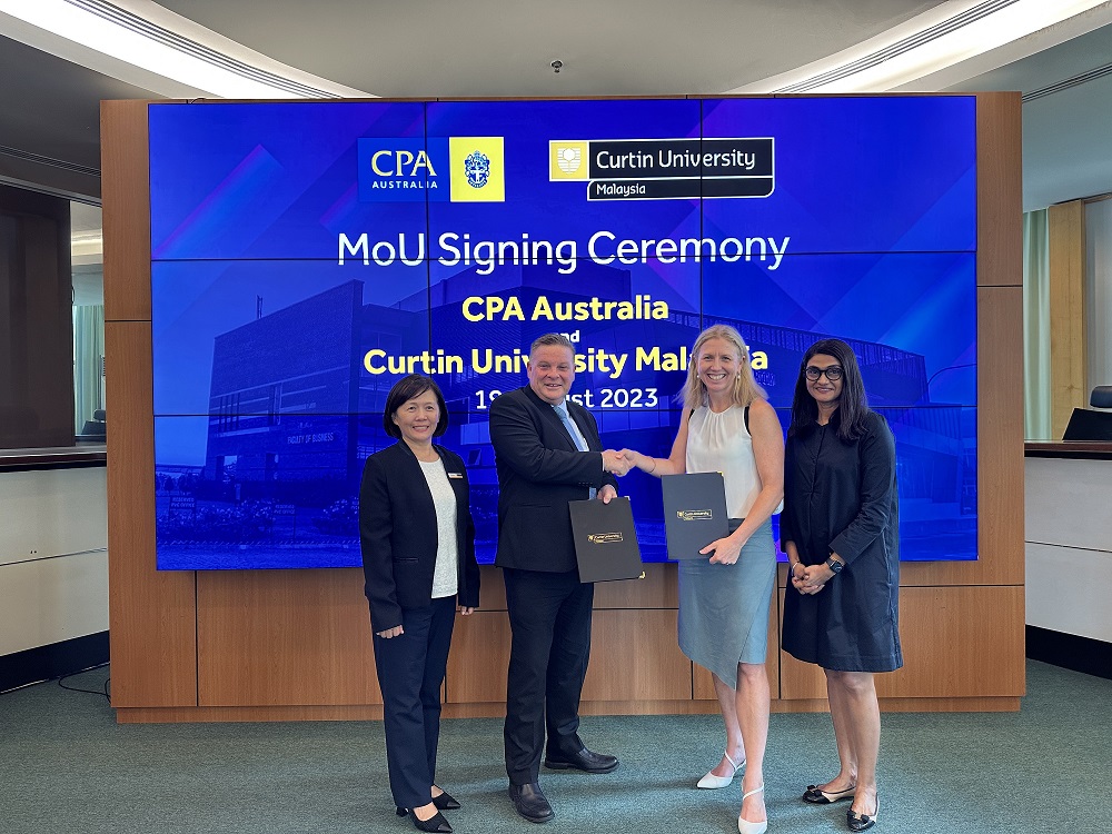 2_Prof Simon Leunig and Rowena Buddee exchanging copies of the MOU as Prof Pauline Ho and Priya Terumalay look on.jpeg