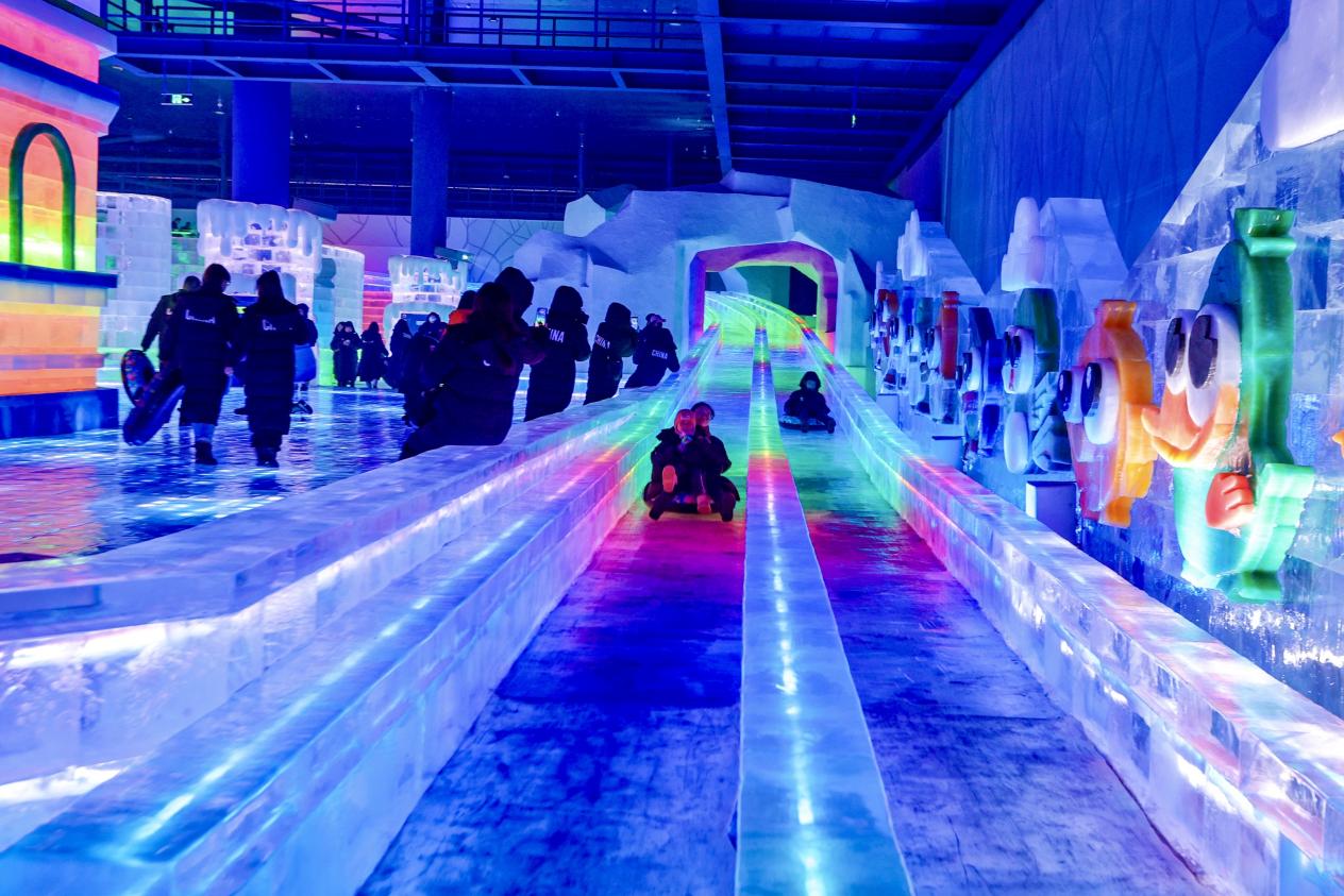 Visitors have fun at an indoor ice and snow theme park in Harbin, northeast China's Heilongjiang Province, July 6, 2024.